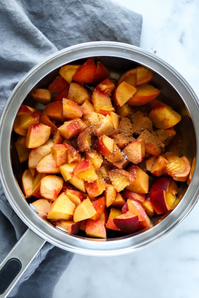 chopped peaches in pan before cooking.