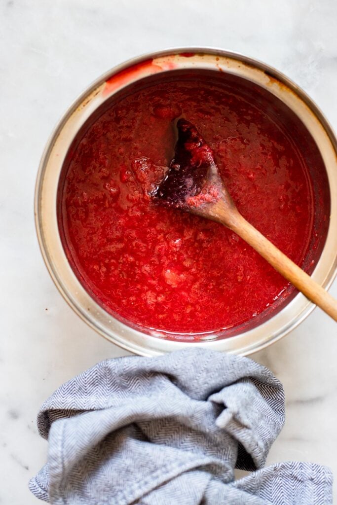 cooked strawberry rhubarb compote in saucepan.