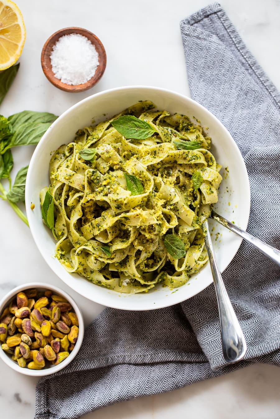 vegan pesto pasta in bowl with fresh basil.