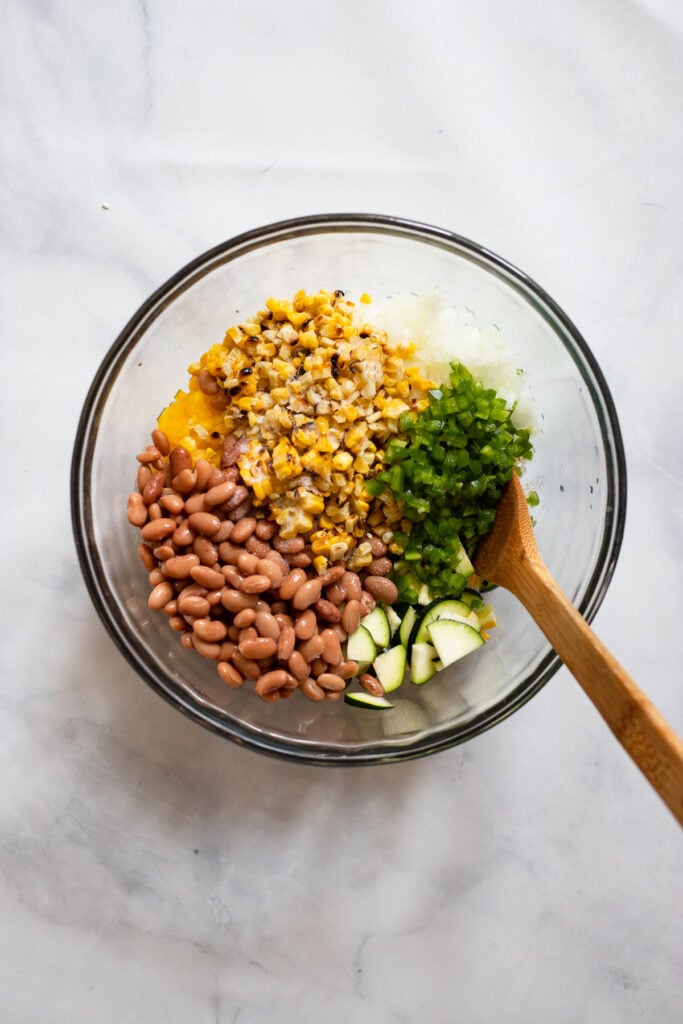 mix beans and chopped vegetables together in a bowl.