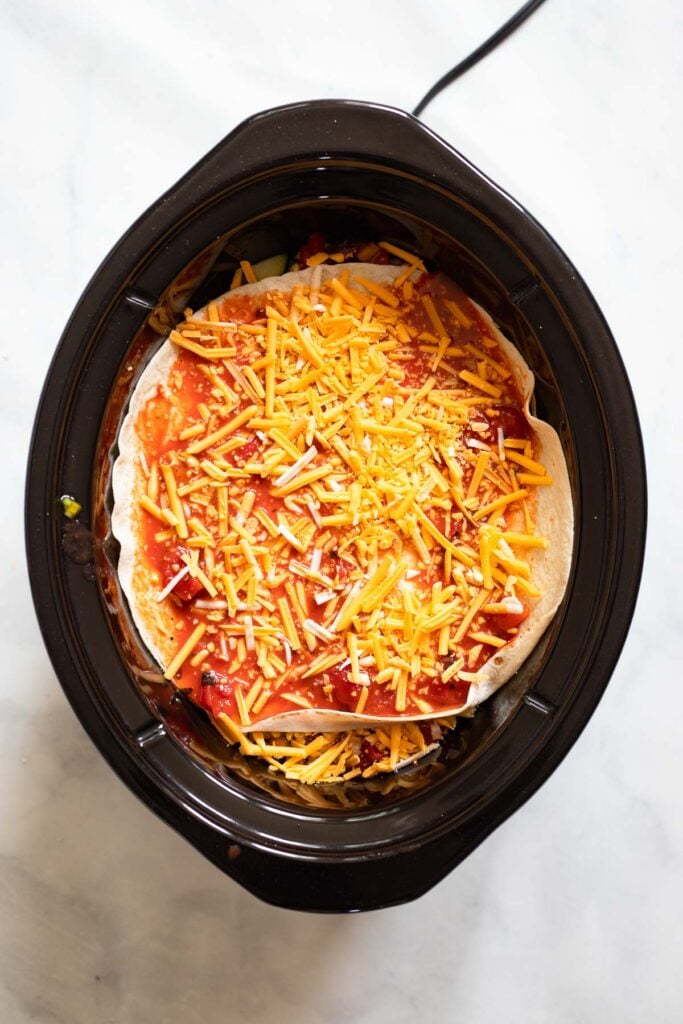 repeat layers and then top with one last tortilla, tomato/enchilada sauce mix, and more cheese