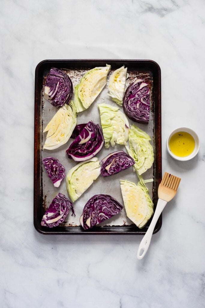 arrange sliced cabbage pieces in single layer on baking sheet. Brush each side with olive oil.