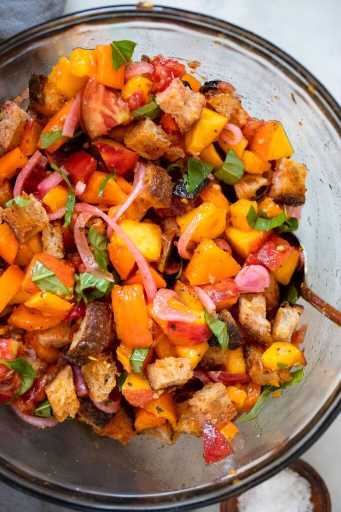 tossed panzanella salad in mixing bowl 
