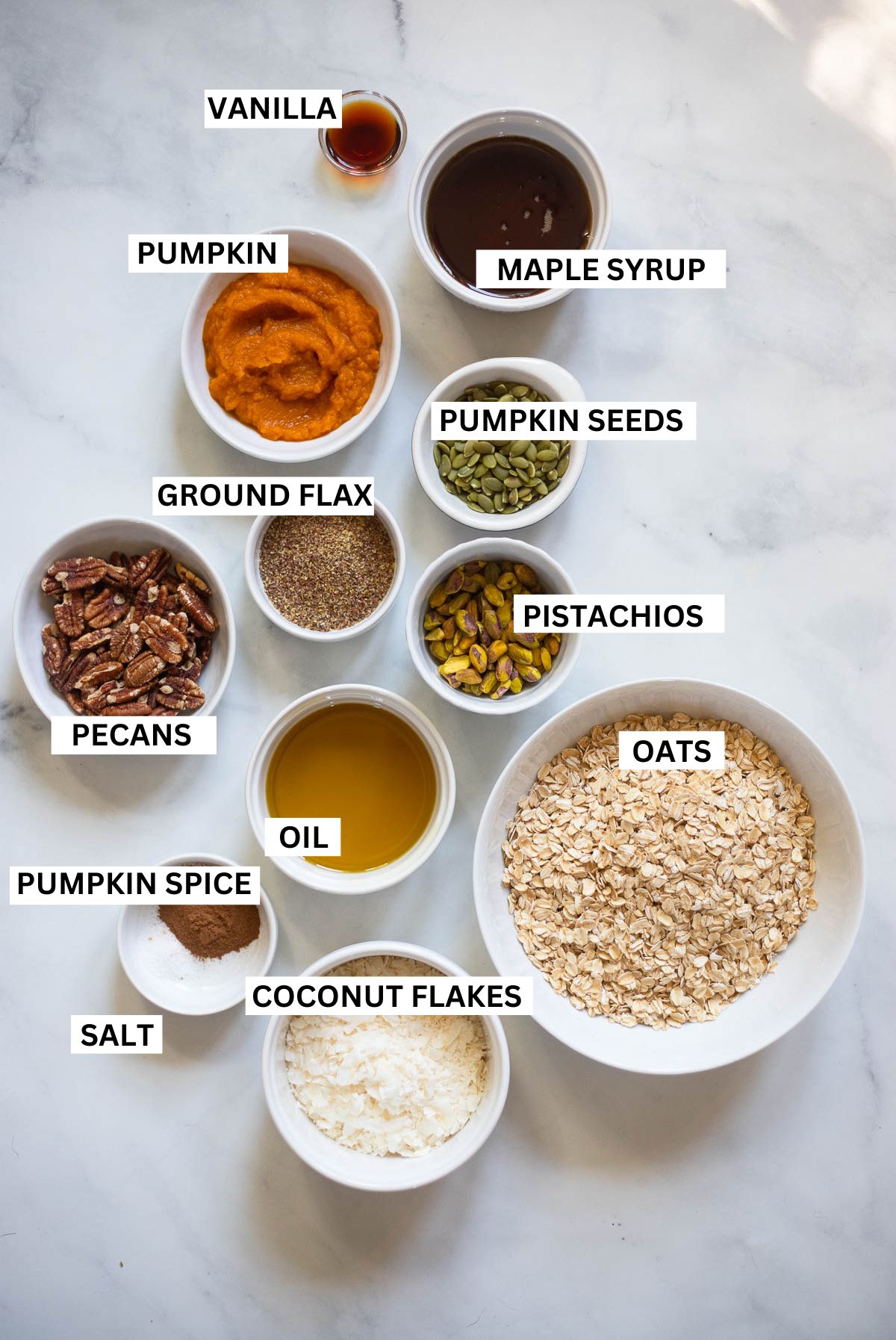 pumpkin spice granola ingredients in bowls. 