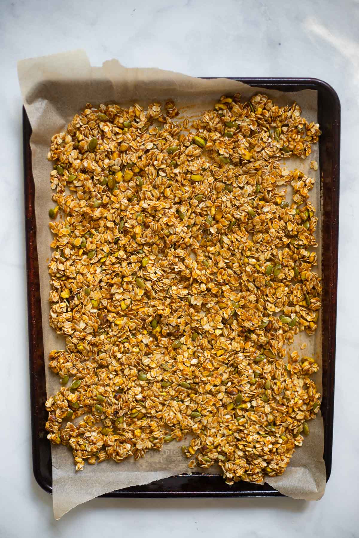 spread granola onto baking sheet lined with parchment paper. 