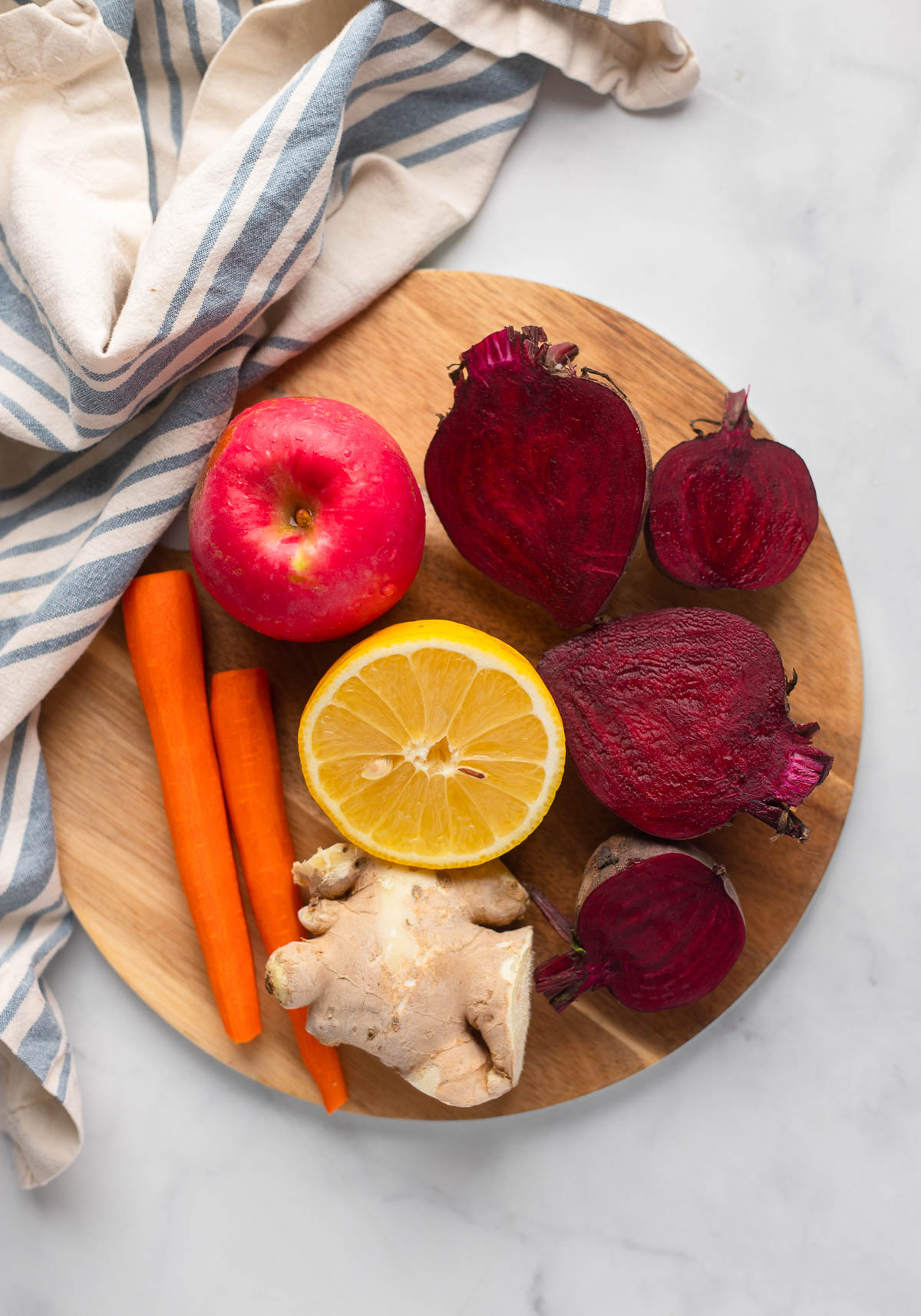 beet juice recipe ingredients on wooden cutting board.