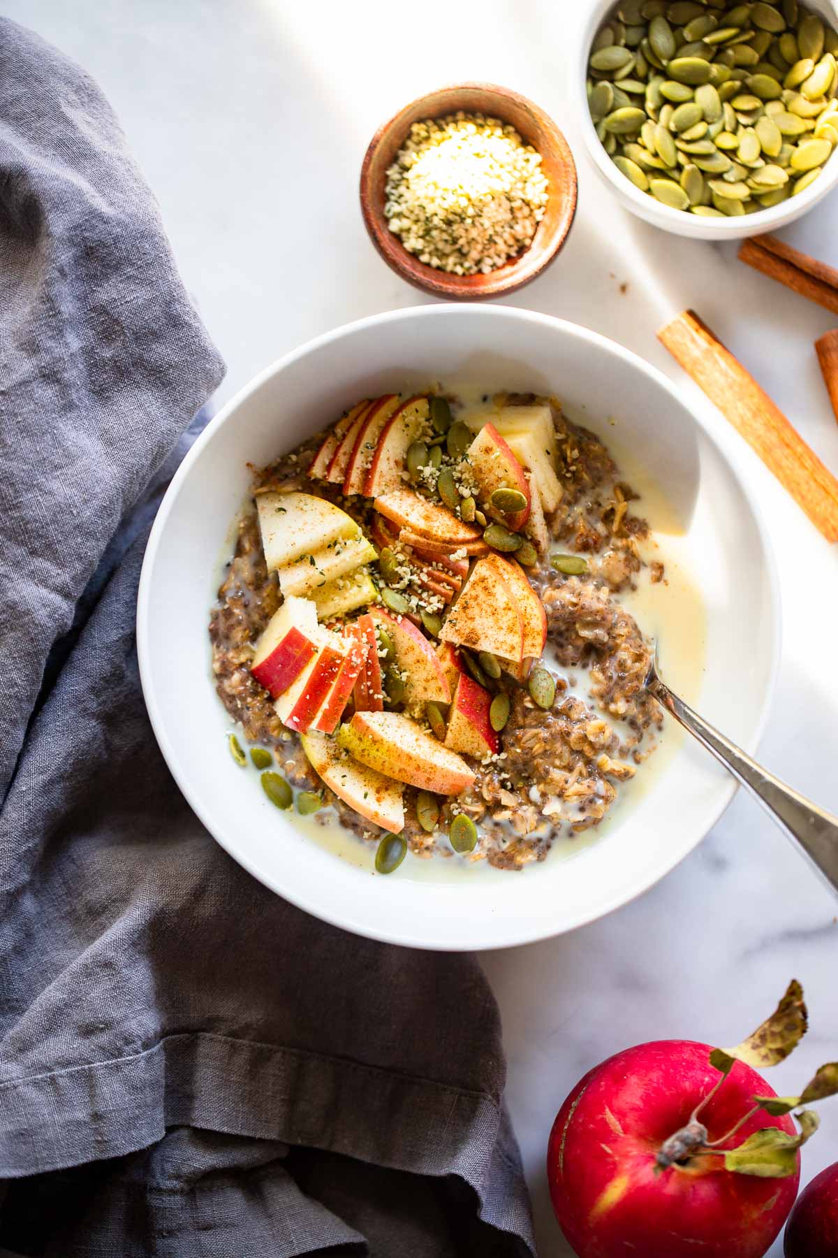 cinnamon oatmeal with sliced apples and pumpkin seeds. 