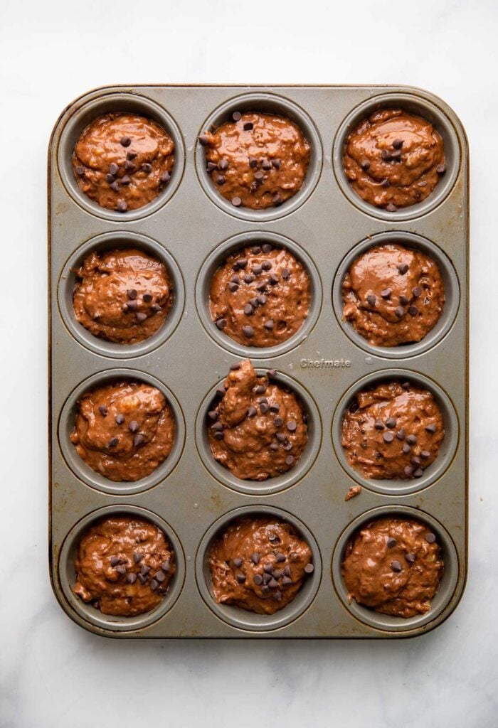 Muffin tin filled with batter.