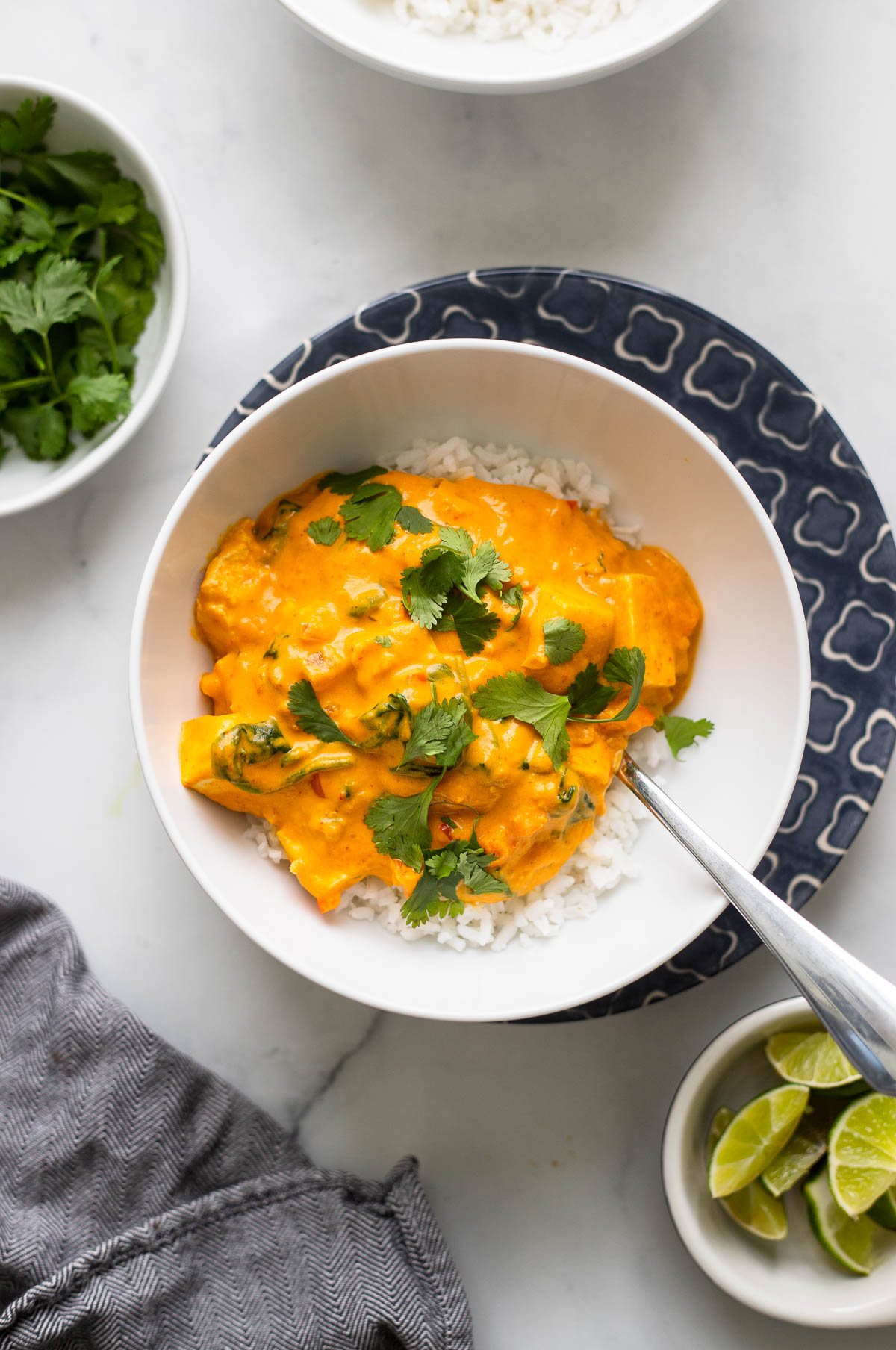 pumpkin curry in bowl garnished with cilantro.