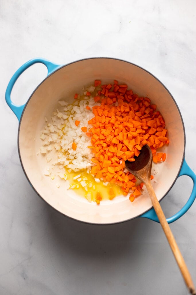 oil, chopped onion, and chopped carrot in dutch oven.