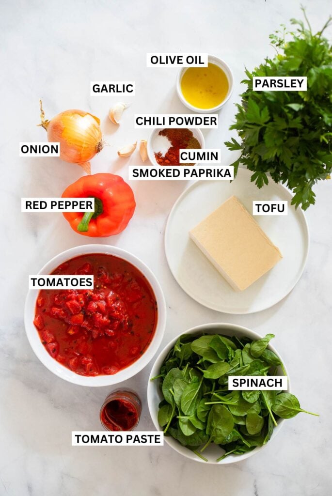 vegan shakshuka ingredients in small dishes with labels. 