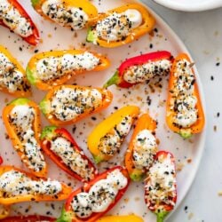 vegan cream cheese stuffed peppers on a white plate.