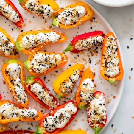 vegan cream cheese stuffed peppers on a white plate.