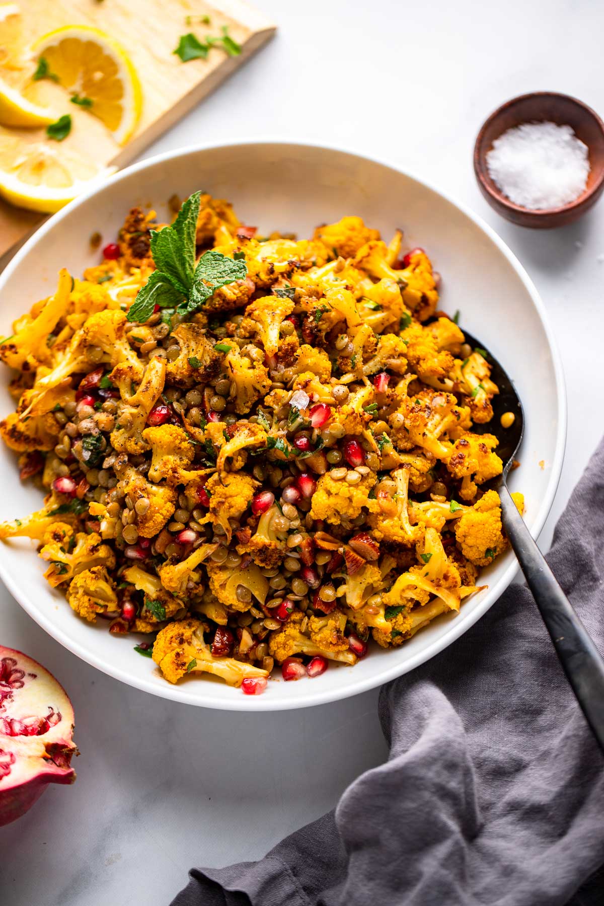 roasted cauliflower salad in bowl with mint and salt.