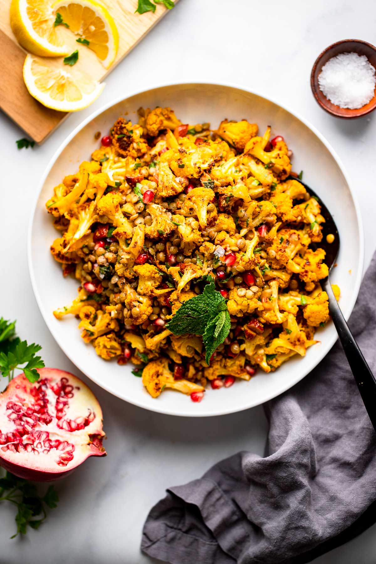 roasted cauliflower salad in large bowl garnished with mint. 