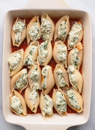 shells in baking dish filled with tofu ricotta.