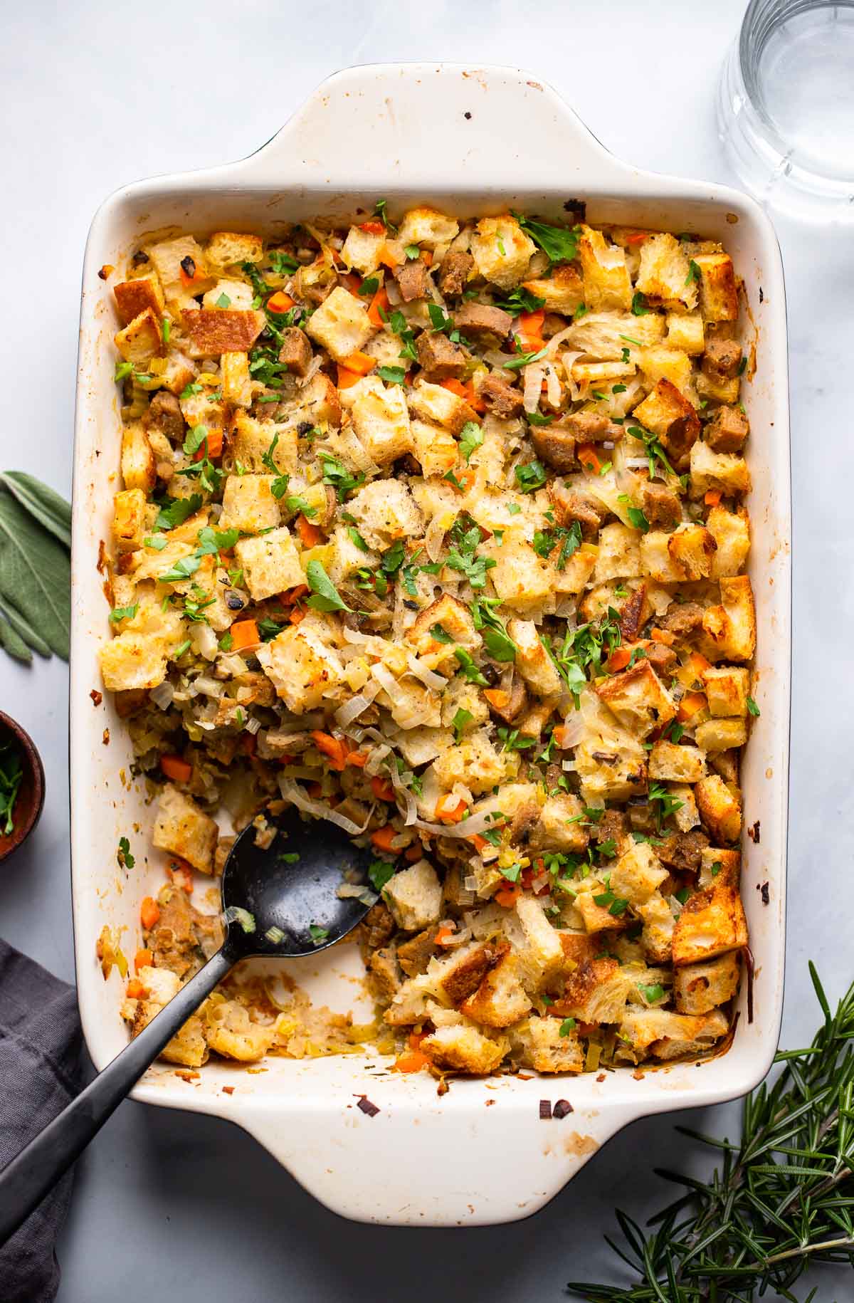 the best vegetarian stuffing in baking dish garnished with chopped parsley.