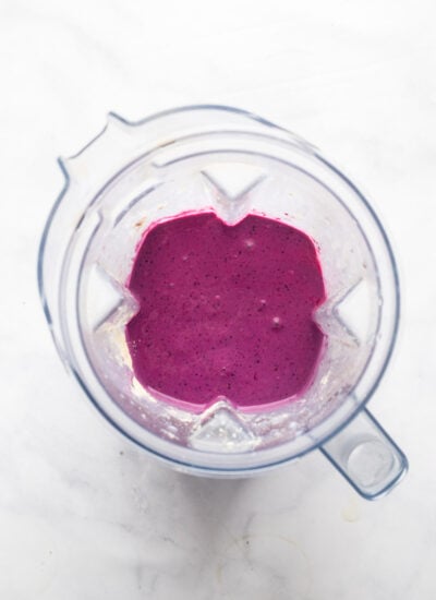 pureed berry smoothie in blender pitcher.