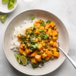 butternut squash chickpea curry in shallow bowl with fork.