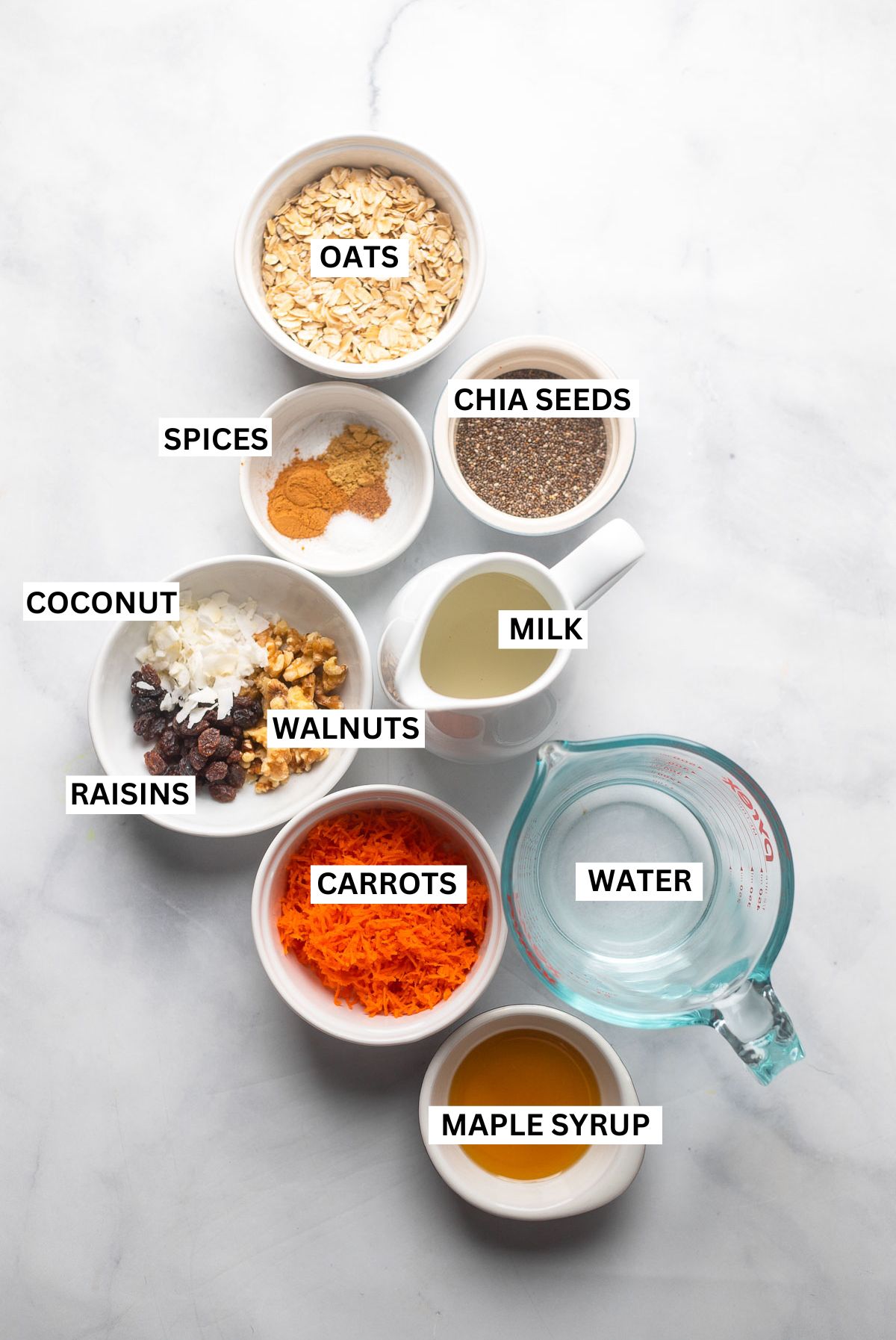 carrot cake oatmeal ingredients in small bowls with labels.