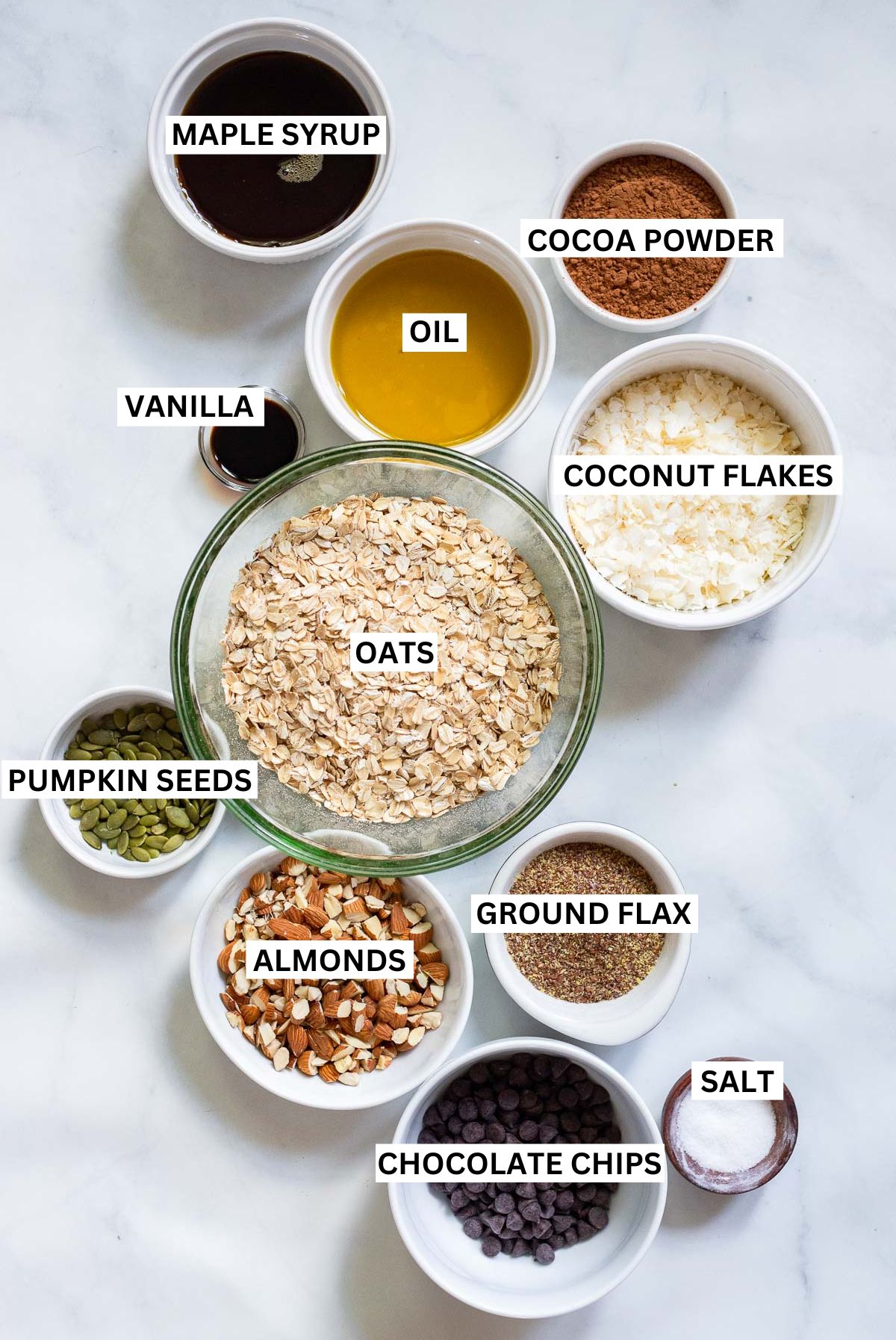 chocolate granola ingredients in bowls with labels.
