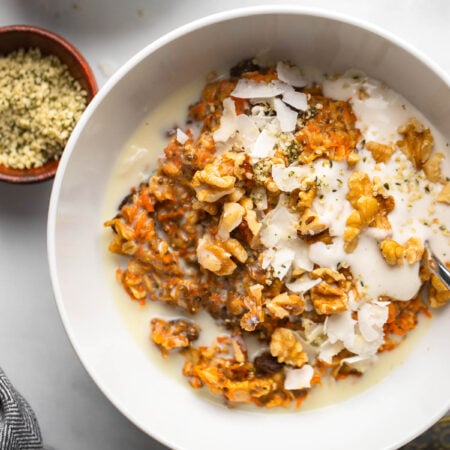 carrot cake oatmeal topped with walnuts and vegan yogurt.