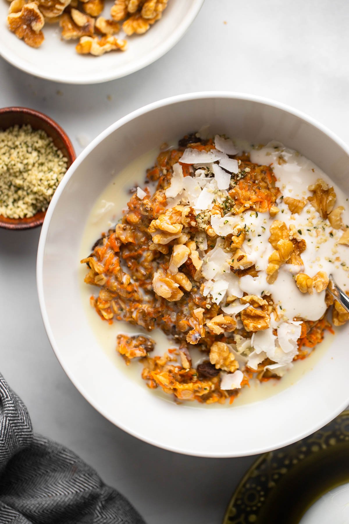 carrot cake oatmeal topped with walnuts and vegan yogurt.