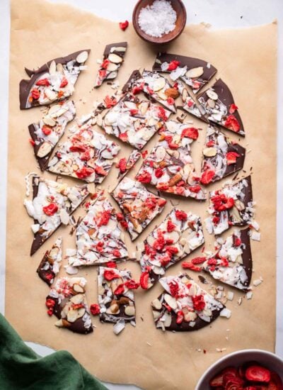 chocolate almond bark pieces on a piece of parchment.