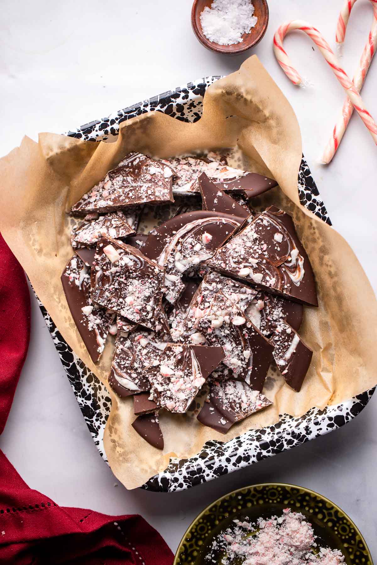 peppermint chocolate bark pieces in a speckled dish.