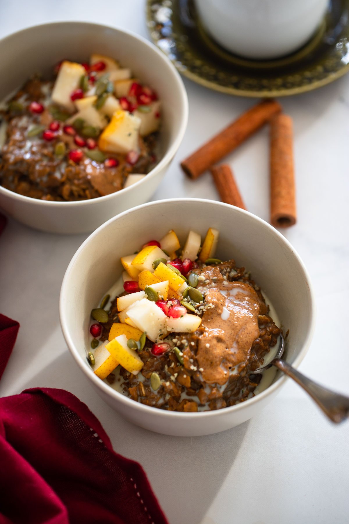 Oatmeal gingerbread topped with melted almond butter, chopped pears and pomegranate.