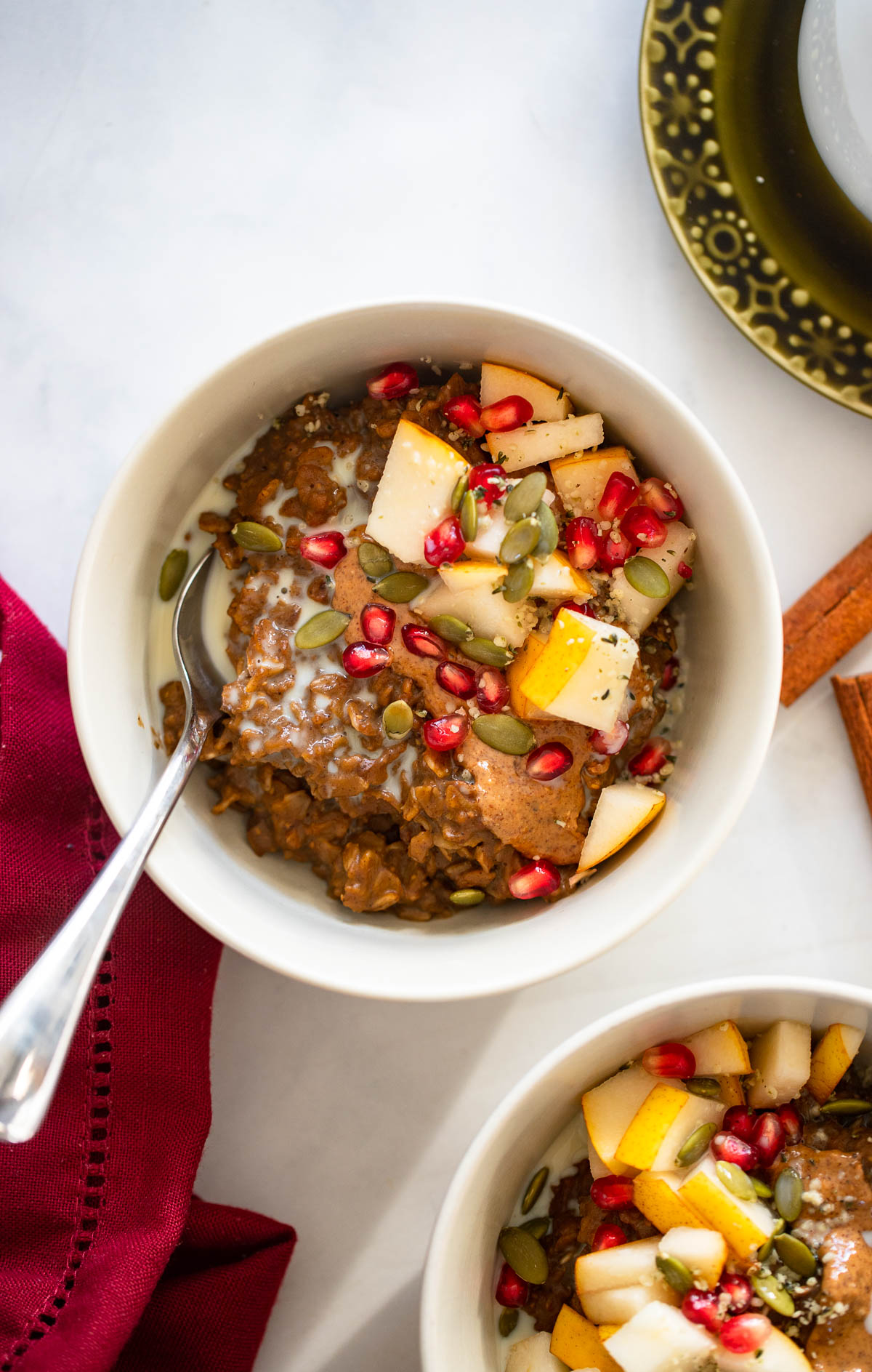 gingerbread oatmeal garnished with chopped pear, pumpkin seeds, and pomegranate.