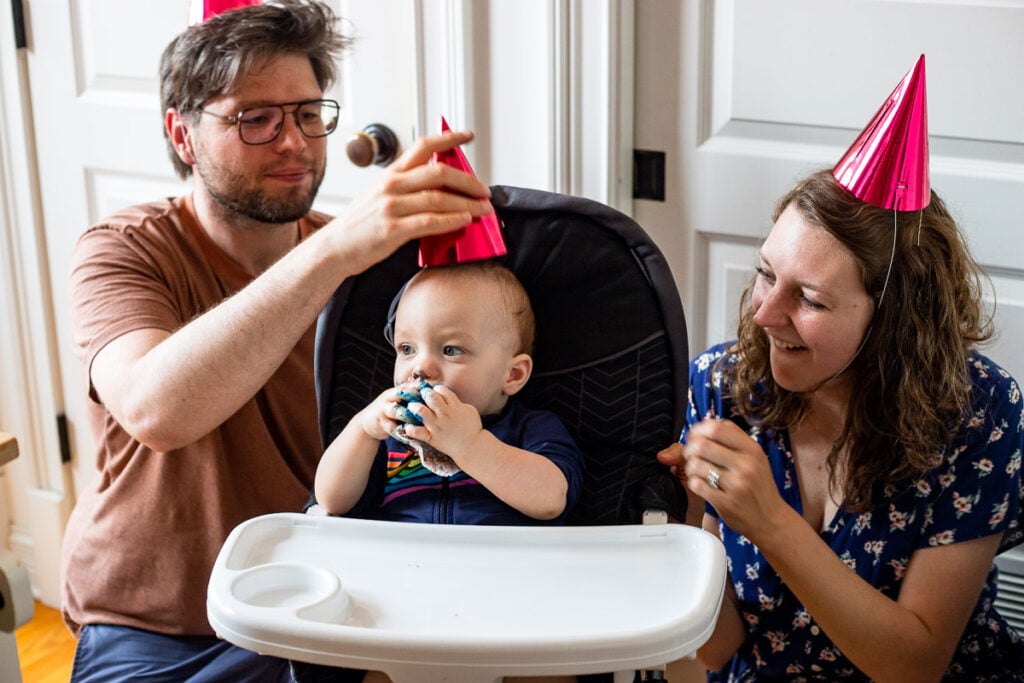 Debbie, Will, and Micah with birthday party hats on their heads.