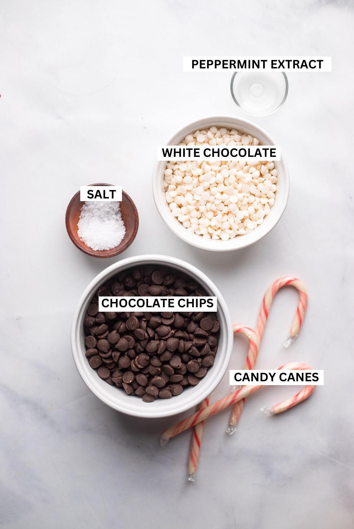 peppermint chocolate bark ingredients in bowls with labels.