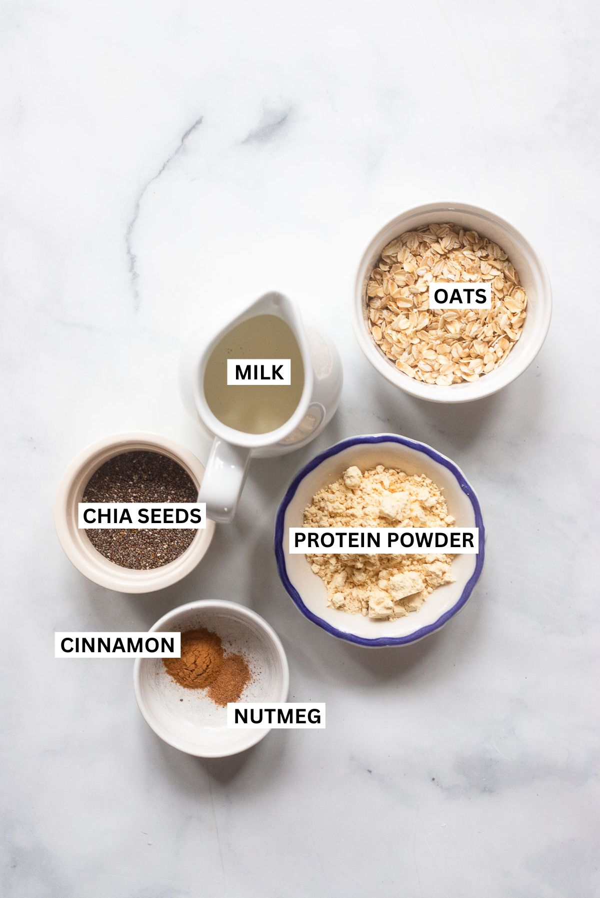 vegan protein overnight oats ingredients in small bowls with labels.
