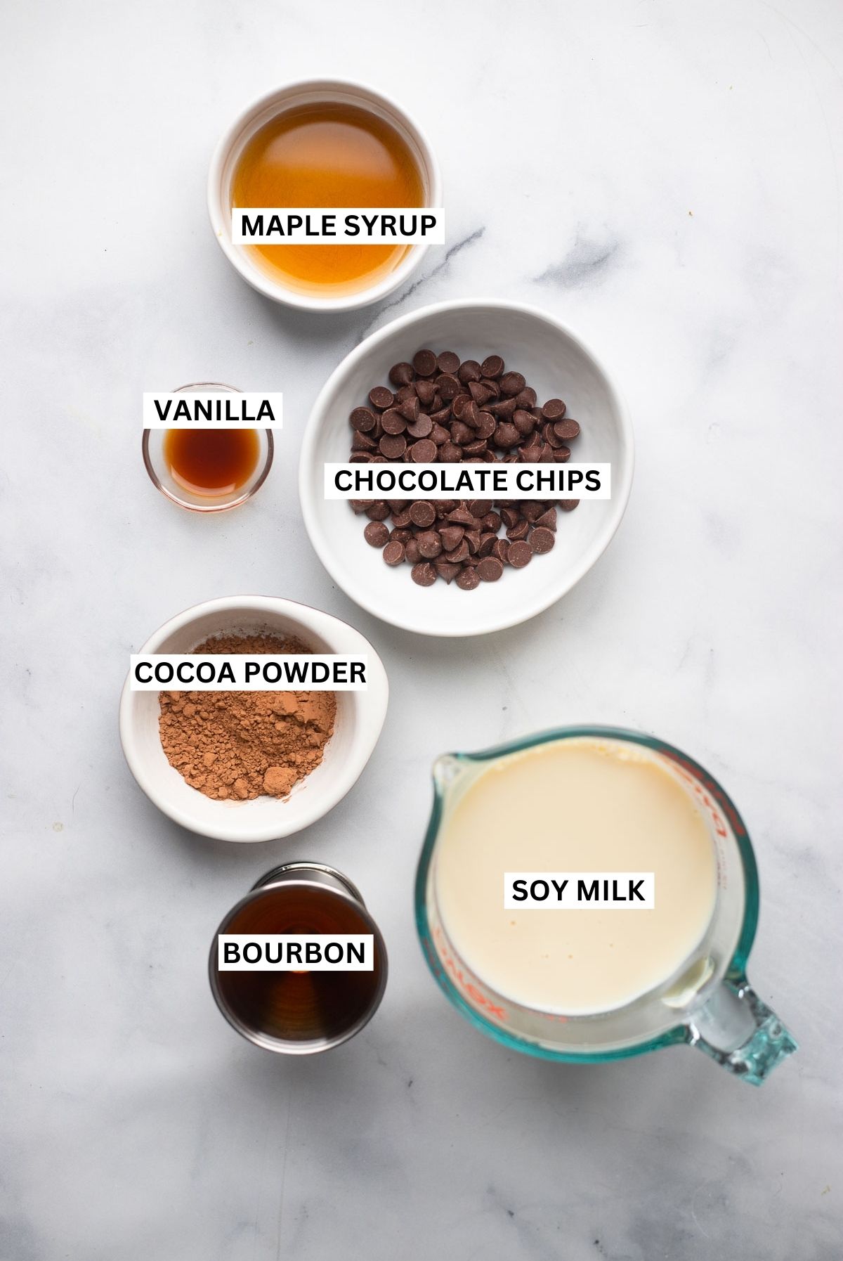 spiked hot chocolate ingredients in small bowls with labels.