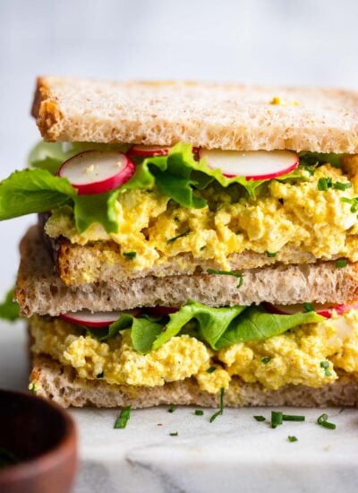 assembled tofu egg salad sandwich with relish and lettuce.