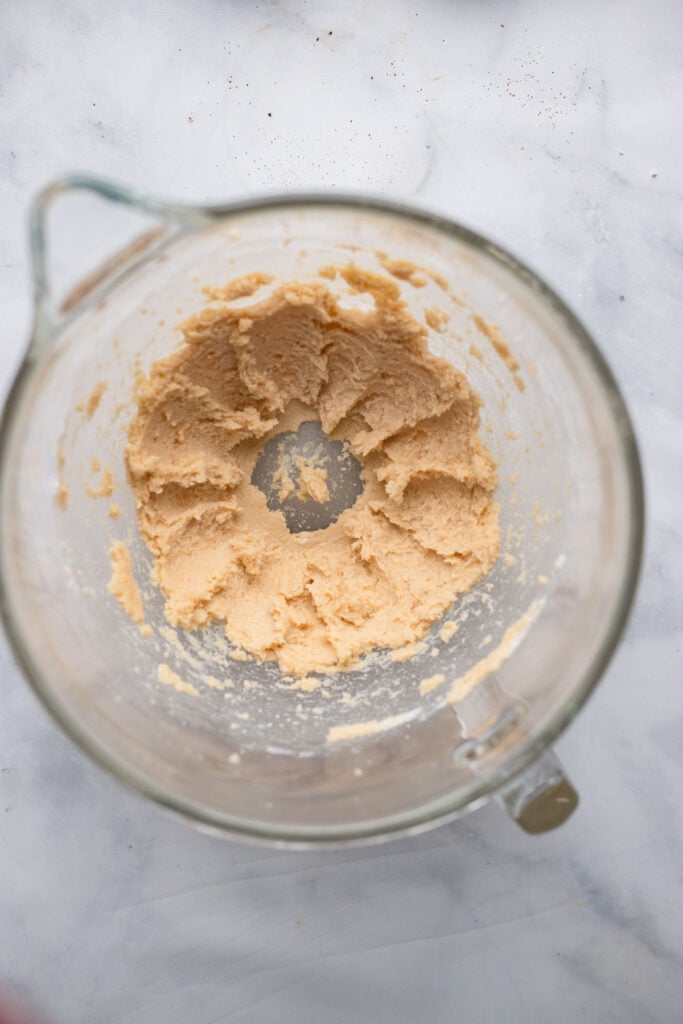 butter and sugars mixed together in bowl.