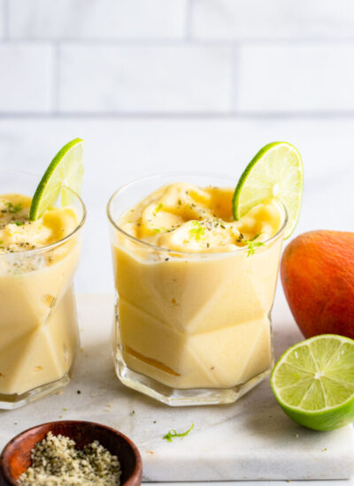 mango pineapple smoothie with slice of lime