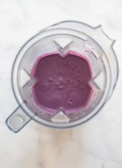 blueberry oat smoothie ingredients in blender pitcher after blending.