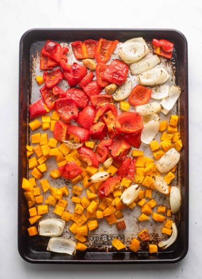 chopped pepper, butternut, and onion on baking sheet after roasting.