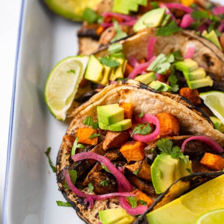 mushroom and sweet potato tacos with red onion and avocado.