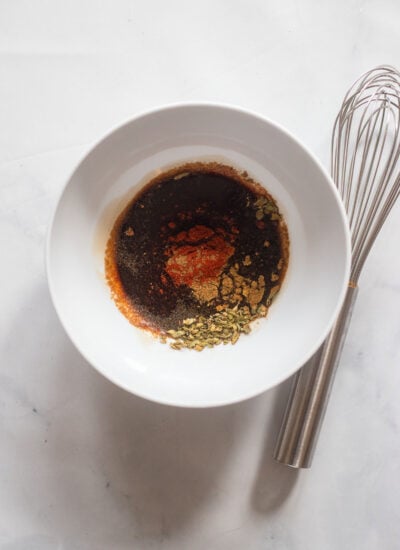 mushroom marinade ingredients in a bowl with a whisk.