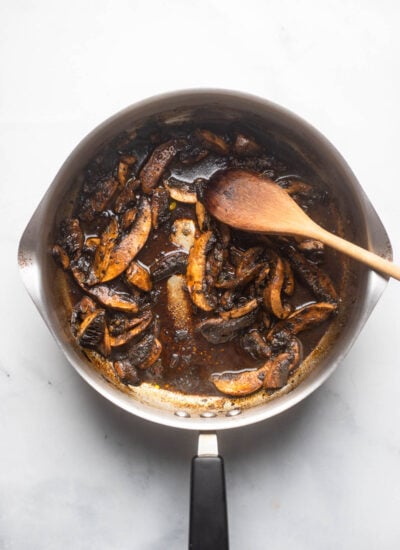 marinated mushrooms cooked until saucy in a skillet.