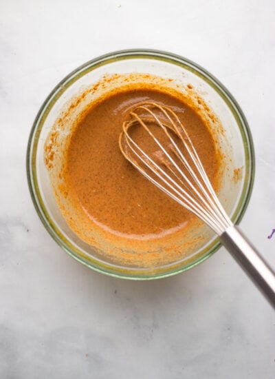 almond butter sauce in small mixing bowl with whisk.