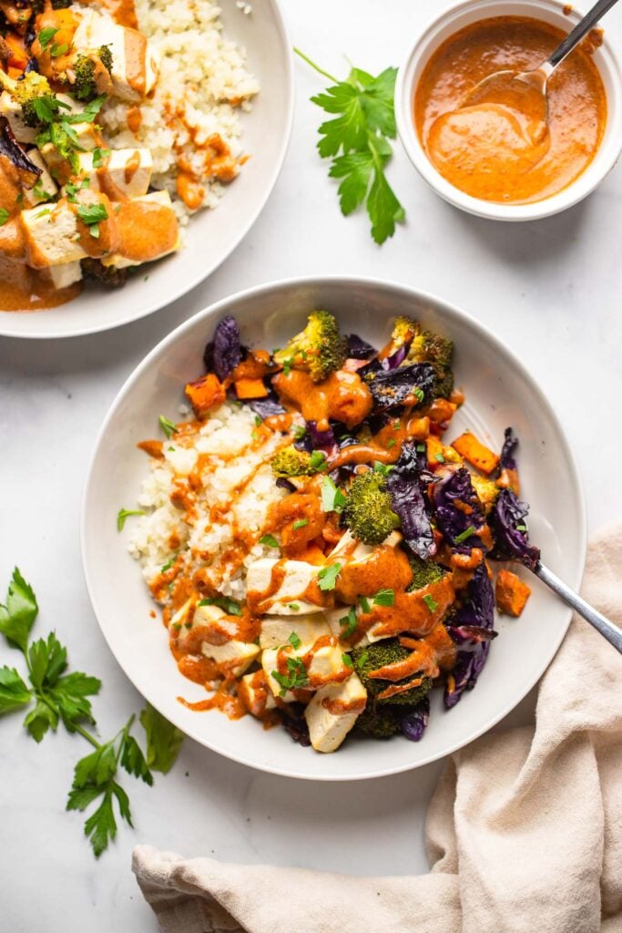 tofu power bowl with spicy almond sauce in bowl.