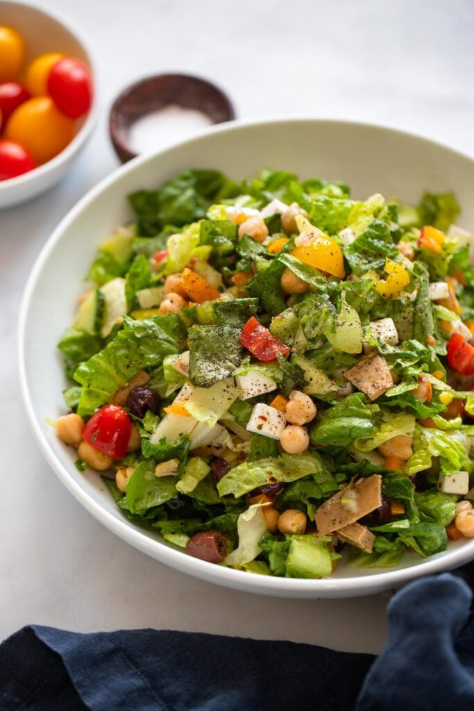 vegan Italian chopped salad in bowl with black pepper.