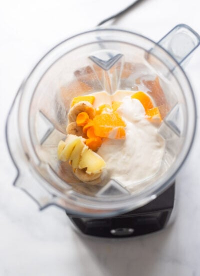 Mango Turmeric Smoothie ingredients in blender jug ​​before blending. 