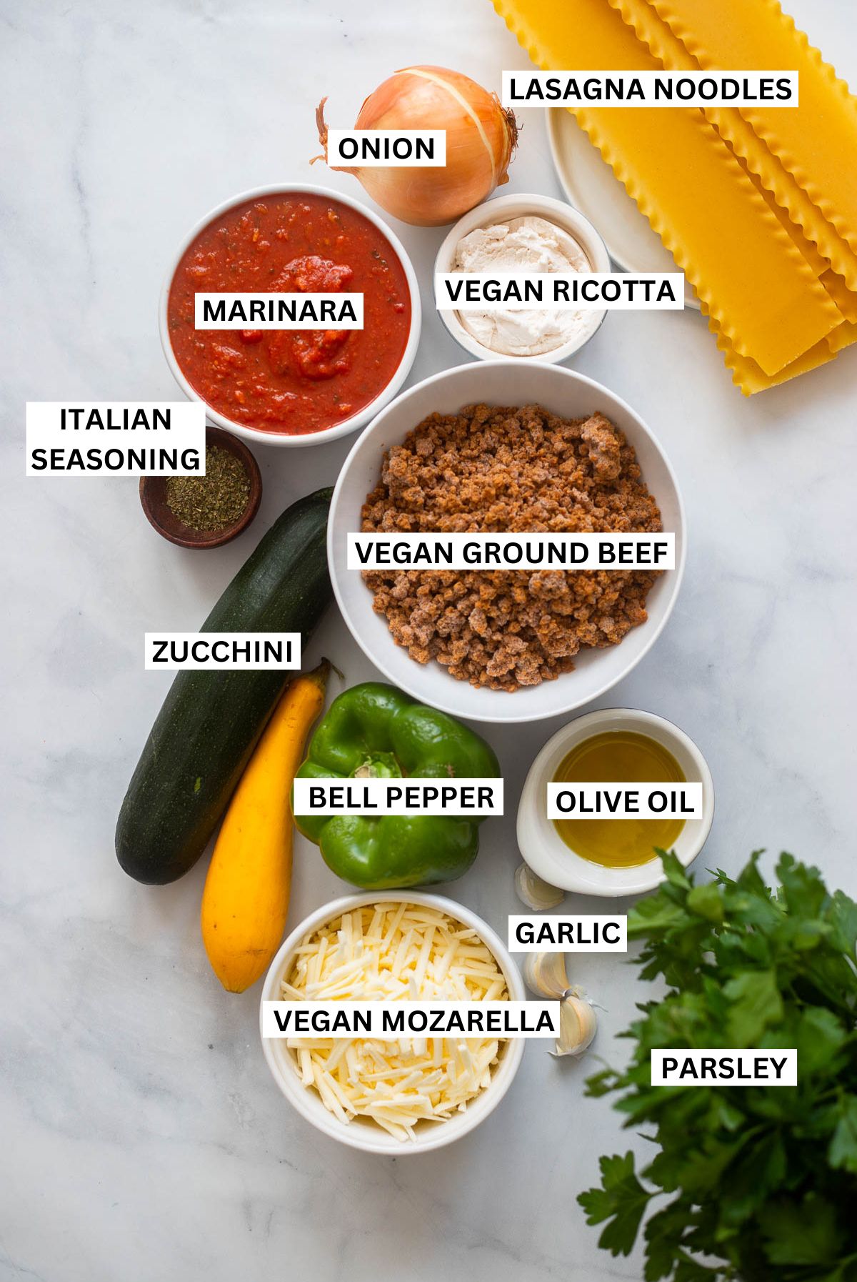 vegan skillet lasagna ingredients in small bowls arranged on table with text overlay for each ingredient.
