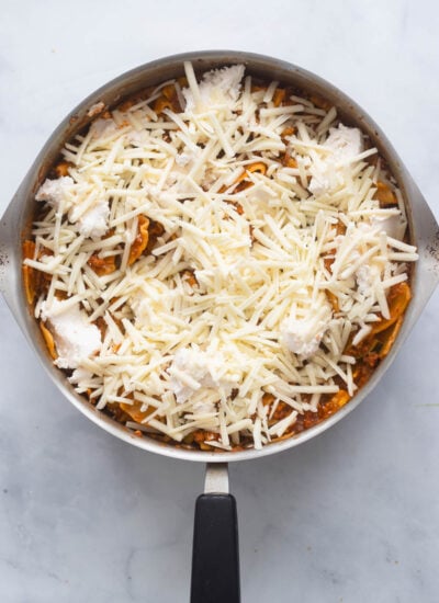 vegan shredded mozzarella cheese added to the top of the lasagna skillet before broiling. 
