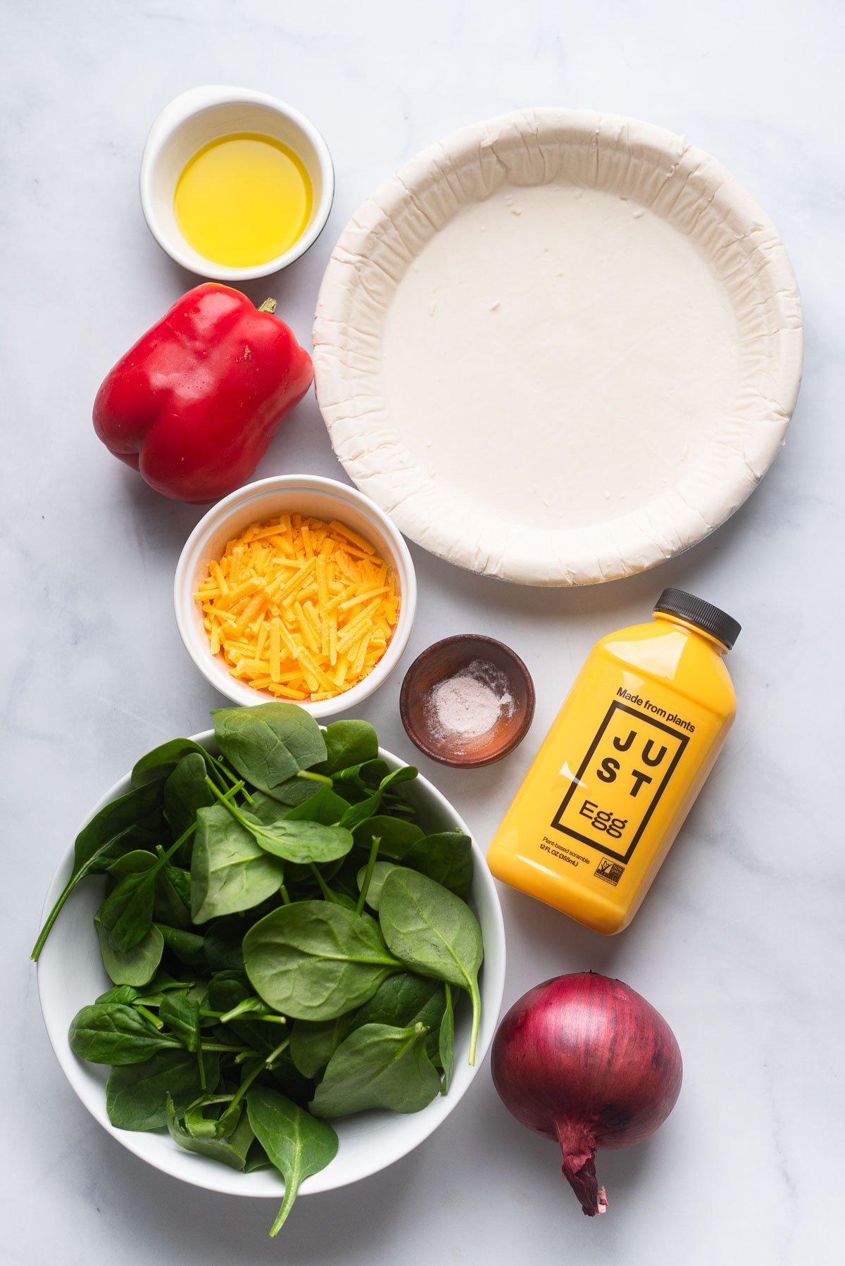 vegan quiche ingredients laid out on a white background. 